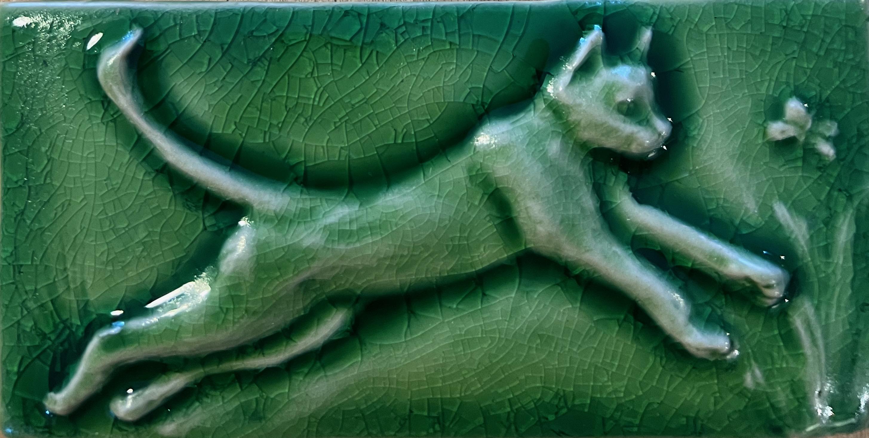 Set of four mischievous cat hand carved subway carved tiles.