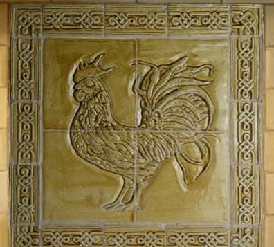Ceramic bas relief cockerel backsplash in wheat glaze and celtic knot border.