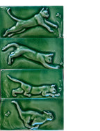 Set of four mischievous cat hand carved subway carved tiles.