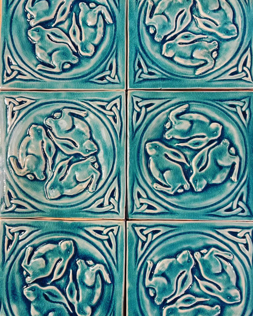 6"Crackle blue Celtic bunnies ceramic tile in stoneware clay .
