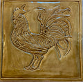 Ceramic bas relief cockerel backsplash in wheat glaze and celtic knot border.