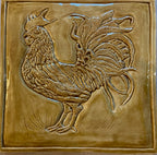 Ceramic bas relief cockerel backsplash in wheat glaze and celtic knot border.
