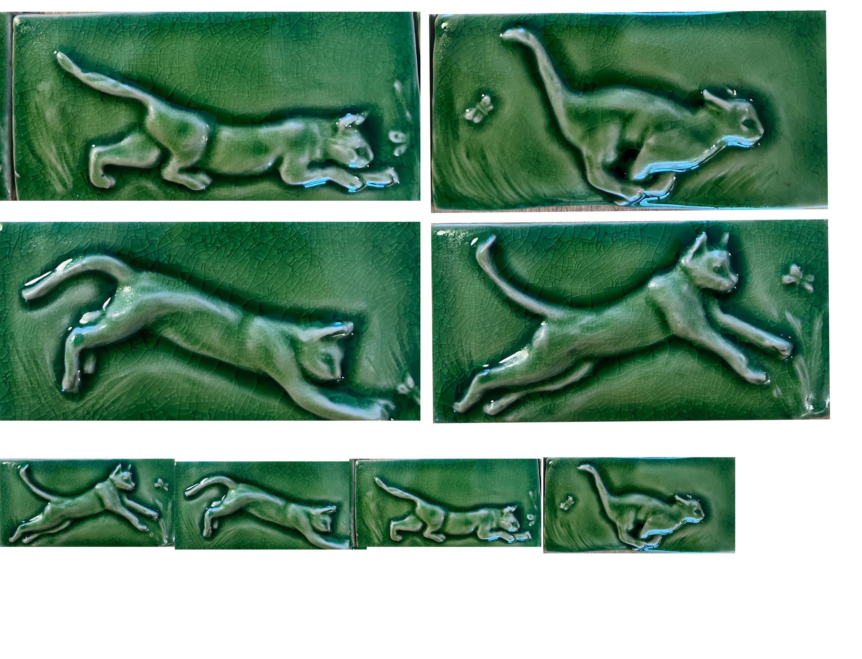 Set of four mischievous cat hand carved subway carved tiles.